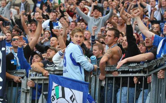Schalke's Lars Unnerstall celebrates with the supporter