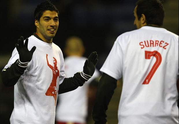 Liverpool players and Kenny Dalglish wear t-shirts in support of Luis Suarez ahead of Premier League game against Wigan