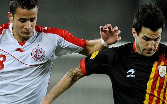 Cesc Fabregas of Catalonia (R) and Khaleo Korbi of Tunisia