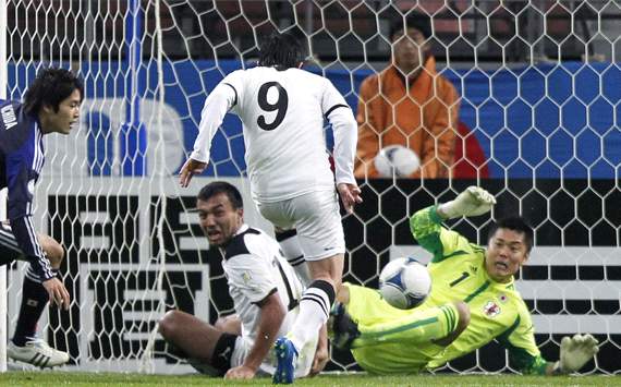 Uzbekistan's Aleksandr Shadrin scores against Japan