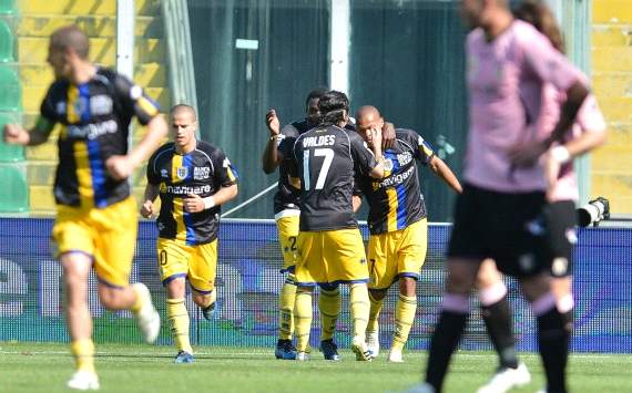 Parma players celebrate a goal against Palermo