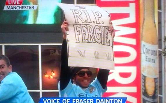 Carlos Tevez holds RIP Fergie sign during Manchester City's parade