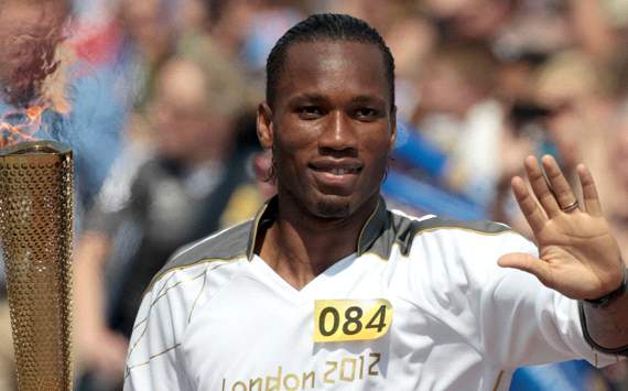 Didier Drogba carries the Olympic flame through Swindon