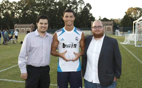 Cristiano Ronaldo receives the Goal.com 50 trophy in Real Madrid's camp at LA from Goal's Eric Gomez and Zac Lee Rigg