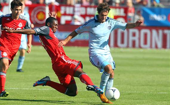 Toronto FC's Doneil Henry tackles Sporting Kansas City Graham Zusi