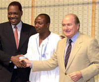 bedi Pele (C) shakes hands with FIFA President Joseph Sepp Blatter (R) and President of the African Soccer Federation Issa Hayatou