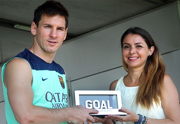 Lionel Messi receives the trophy from Goal's Barcelona writer Pilar Suarez