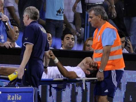 Fabio Grosso being stretchered off early on for Italy against Cyprus with an injury.