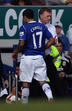 Walk of shame: Everton's Tim Cahill heading past his manager David Moyes and down the tunnel after being sent off in the Merseyside derby defeat to Liverpool.
