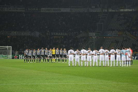 The Juventus and Real Madrid players observe a minute silence prior to kick-off in honour of two Bianconeri fans who died in a road crash on their way to watch the game.