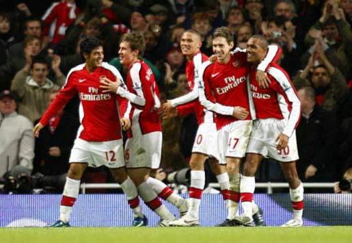Young Gunners: Arsenal's tots celebrates one of Jay Simpson's two strikes against Wigan Athletic.