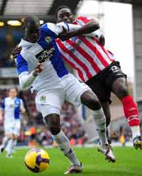Tussle of the muscle: The sturdy pairing of Kenwyne Jones and Chris Samba clash during the Premier League tie between Blackburn and Sunderland