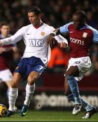 Cristiano Ronaldo of Manchester United and Aston Villa's Nigel Reo-Coker battle for supremacy (PA)