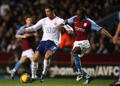Cristiano Ronaldo of Manchester United and Aston Villa's Nigel Reo-Coker battle for supremacy (PA)