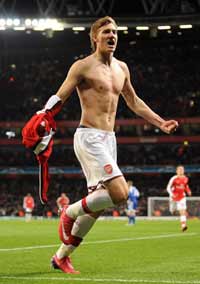 Arsenal's Nicklas Bendtner braves a cold London night to celebrate his winner against Dynamo Kyiv.