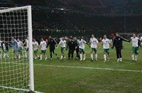 Panathinaikos players and coaches join hands in celebration of their Champions League win over Inter Milan.
