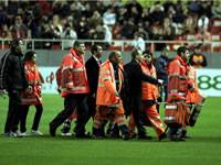 FK Partizan midfielder Moreira is safely carried off the pitch after fainting in the opening minutes of the UEFA Cup clash at Sevilla (MARCA)