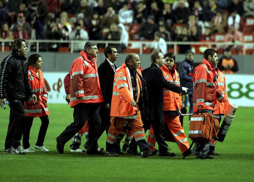 FK Partizan midfielder Moreira is safely carried off the pitch after fainting in the opening minutes of the UEFA Cup clash at Sevilla (MARCA)