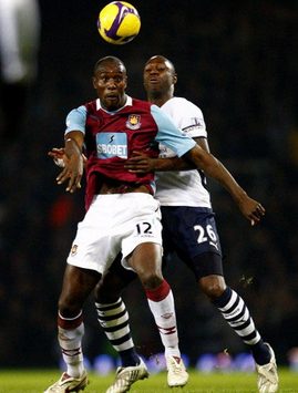 Carlton Cole and Ledley King jump for control of the ball as West Ham take on Tottenham.