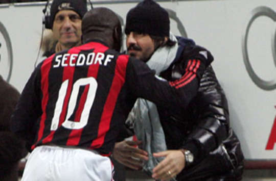 Clarence Seedorf cheers up injured Gennaro Gattuso by celebrating a goal with him during Milan's emphatic 5-1 triumph over Udinese (Grazia Neri)
