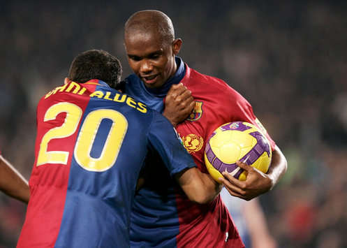 Hugz! Dani Alves cuddles goalscorer Samuel Eto'o as Barcelona romp to a 5-0 win over Deportivo La Coruna.
