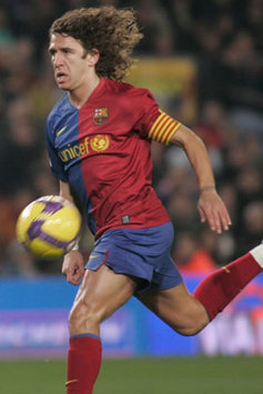 Barcelona captain Carles Puyol in the thick of the action for his side in the 5-0 thrashing of Deportivo.