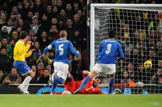 Elano watches on as the ball ripples the back of the net for Brazil's opening goal against Italy (PA)