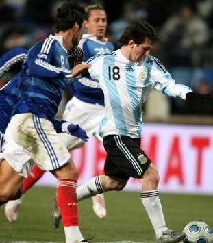 Don't mess with me! Argentina's Lionel Messi careens past a wall of French players as he helped his side to a 2-0 friendly win in Marseille