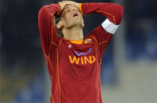 Francesco Totti shows his frustration after his Roma side are eliminated from the Champions League against Arsenal