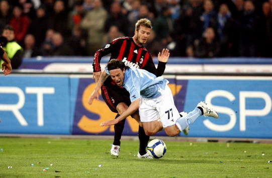 Milan midfielder David Beckham tussles with Davide Mannini during the 0-0 stalemate with Napoli