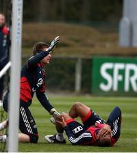 France goalkeeper Cedric Carrasso stops Jimmy Briand's effort in training with the France national side, as the striker goes down with a knock