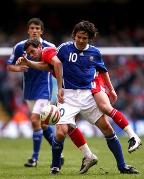 Joe Ledley tries to muscle Jari Litmanen off the ball in Wales vs Finland (PA)