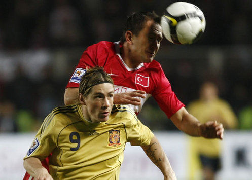 Spain's Fernando Torres fights with Turkey's Emre Asik during their recent World Cup Qualifier