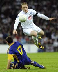 Wayne Rooney in full flight as he skips a challenge from Ukraine's Taras Mykhalyk during their World Cup Qualifier at Wembley