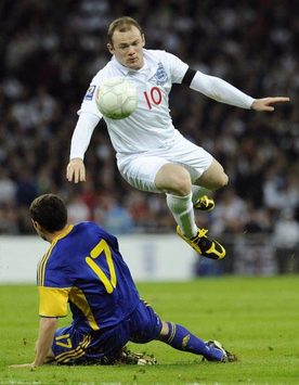 Wayne Rooney in full flight as he skips a challenge from Ukraine's Taras Mykhalyk during their World Cup Qualifier at Wembley