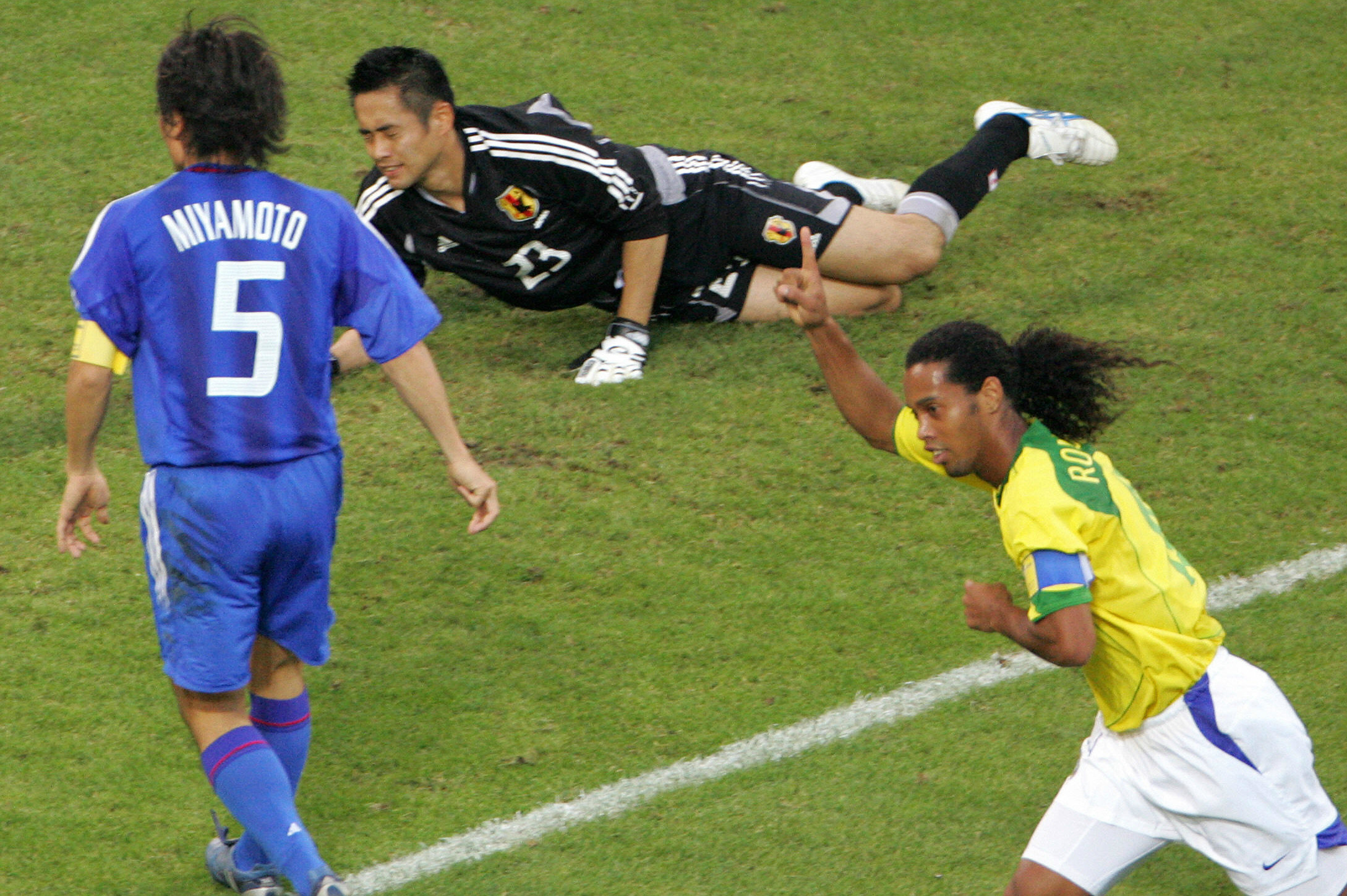 Brazilian Ronaldinho Gaucho jumps over his teammates to celebrate