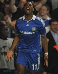 Didier Drogba celebrates his strike against Liverpool as Chelsea march on to the Champions League semi-finals