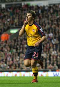 Andrey Arshavin opens the scoring at Anfield, attempting to quiet the noisy crowd.