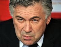 Milan coach Carlo Ancelotti watches his side in action from the San Siro bench as they beat Torino 5-1
