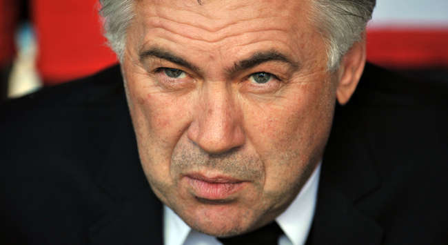 Milan coach Carlo Ancelotti watches his side in action from the San Siro bench as they beat Torino 5-1