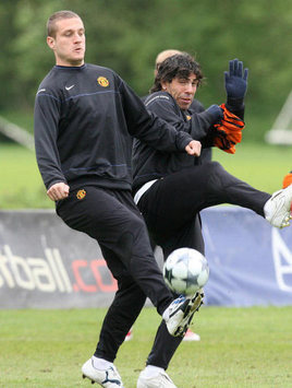 Carlos Tevez and Nemanja Vidic - Manchester United (PA)
