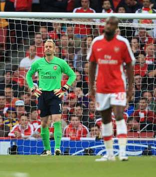 Gunned Down! Arsenal goalkeeper Manuel Almunia looks distraught after his side crash out of the Champions League to Manchester United