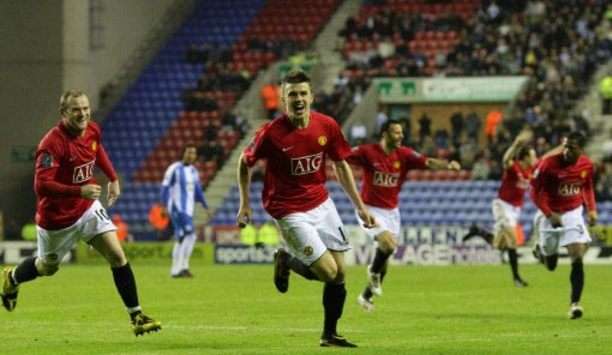 Michael Carrick grabs the winner for Manchester United against Wigan Athletic to send his side within a point of the title