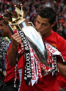 Like an old friend, Cristiano Ronaldo pecks the cheek of the Premier League trophy for a third time (PA)