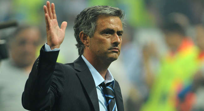 Inter coach Jose Mourinho salutes the fans after his side lift their fourth successive title