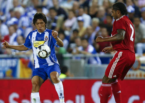 Espanyol's shunsuke Nakamura tussles with Liverpool's Glen Johnson during their friendly match