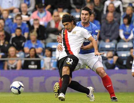 EPL: Carlos Tevez - Richard Hughes, Portsmouth v Manchester City (PA)