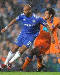 Nicolas Anelka and Bruno Alves battle through the rain as Chelsea face Porto (PA)