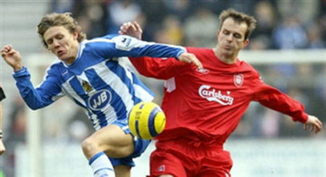 Liverpools Hamann is challenged by Wigans Bullard (AFP)