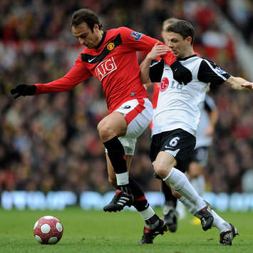 Dimitar Berbatov if Manchester United holds off Chris Baird of Fulham during the Barclays Premier League match between Manchester United and Fulham(Getty Images)